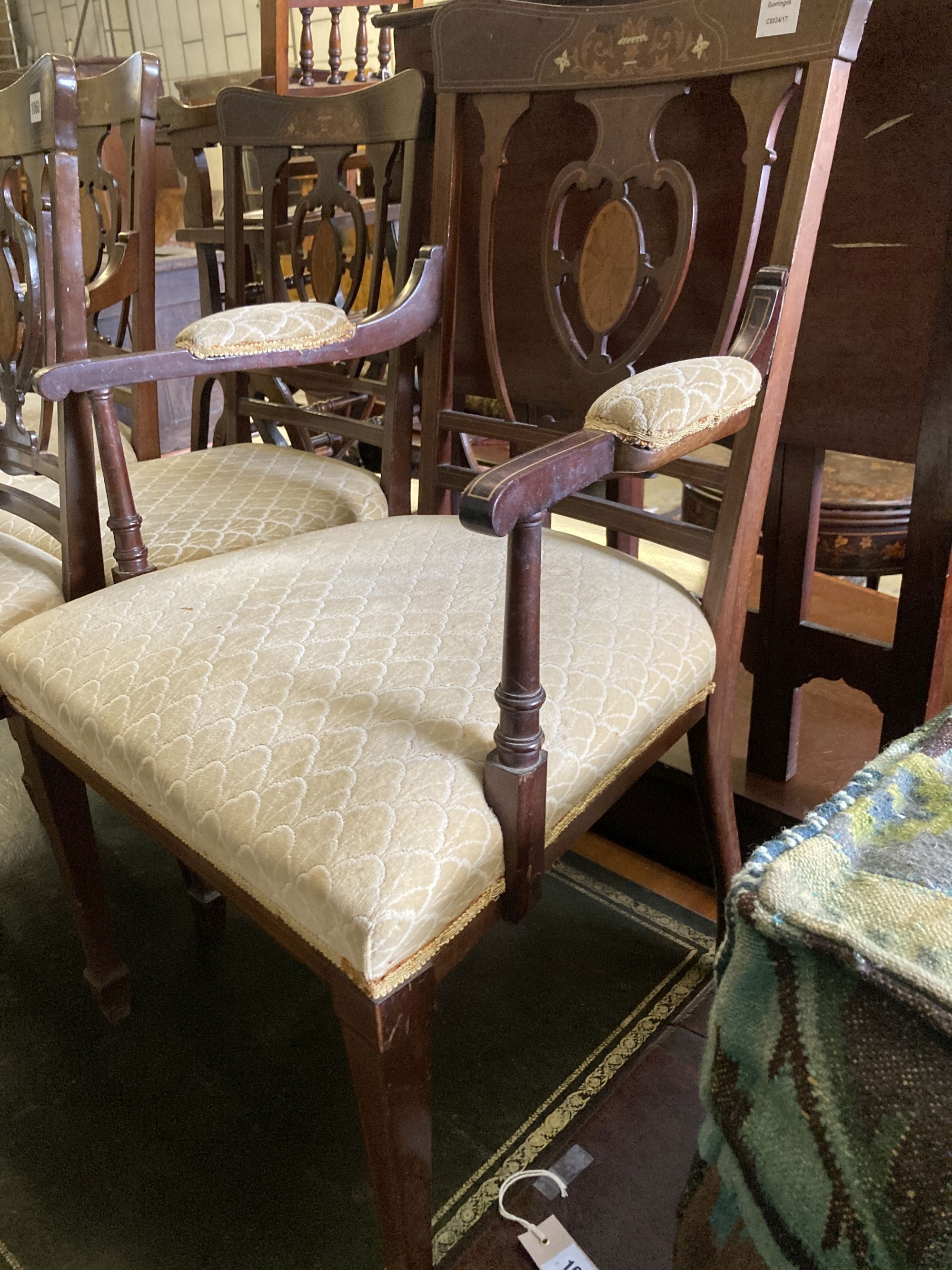 A pair of Edwardian inlaid mahogany elbow chairs and two matching single chairs
